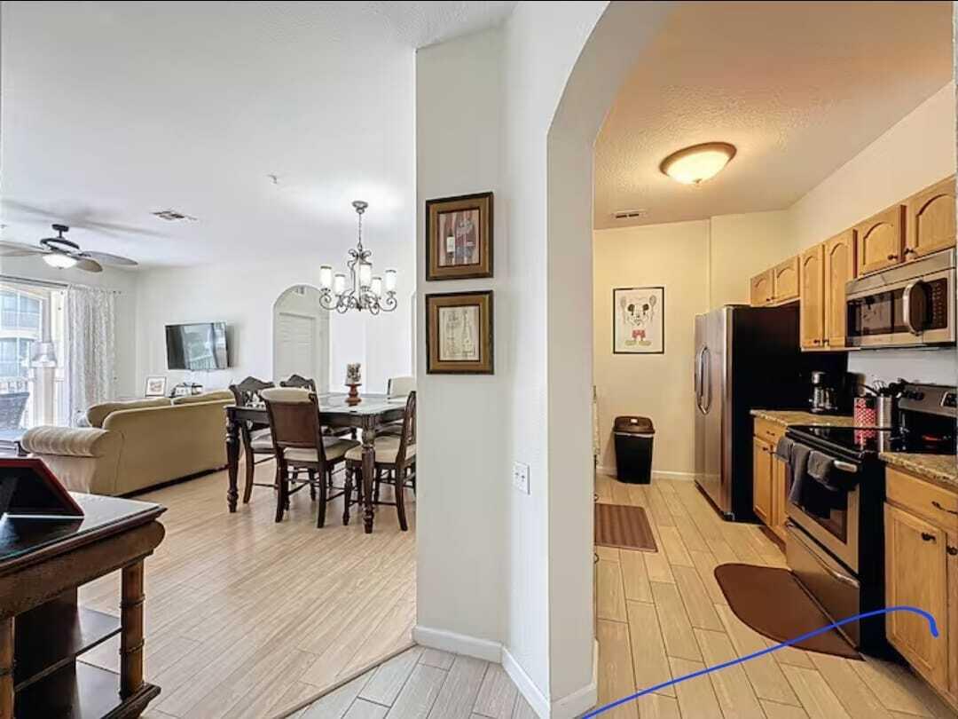 2784 Almaton Loop, Unit 301 Kissimmee, FL 34747 - Photo 16 of 37 a view of a dining room with furniture and a kitchen