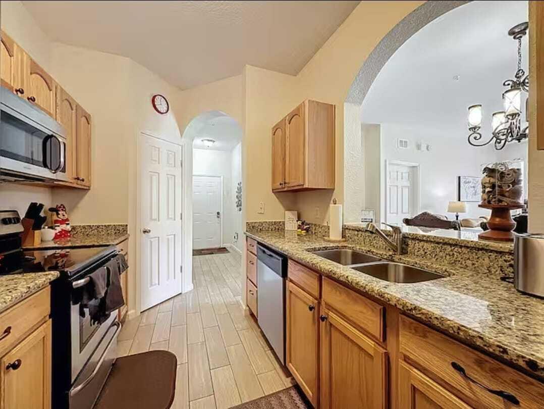 2784 Almaton Loop, Unit 301 Kissimmee, FL 34747 - Photo 18 of 37 a kitchen with a sink stove and cabinets