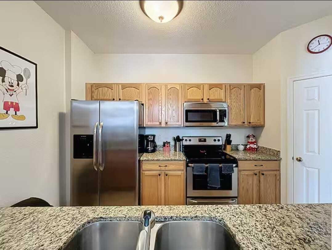 2784 Almaton Loop, Unit 301 Kissimmee, FL 34747 - Photo 19 of 37 a kitchen with stainless steel appliances granite countertop a refrigerator and a stove top oven