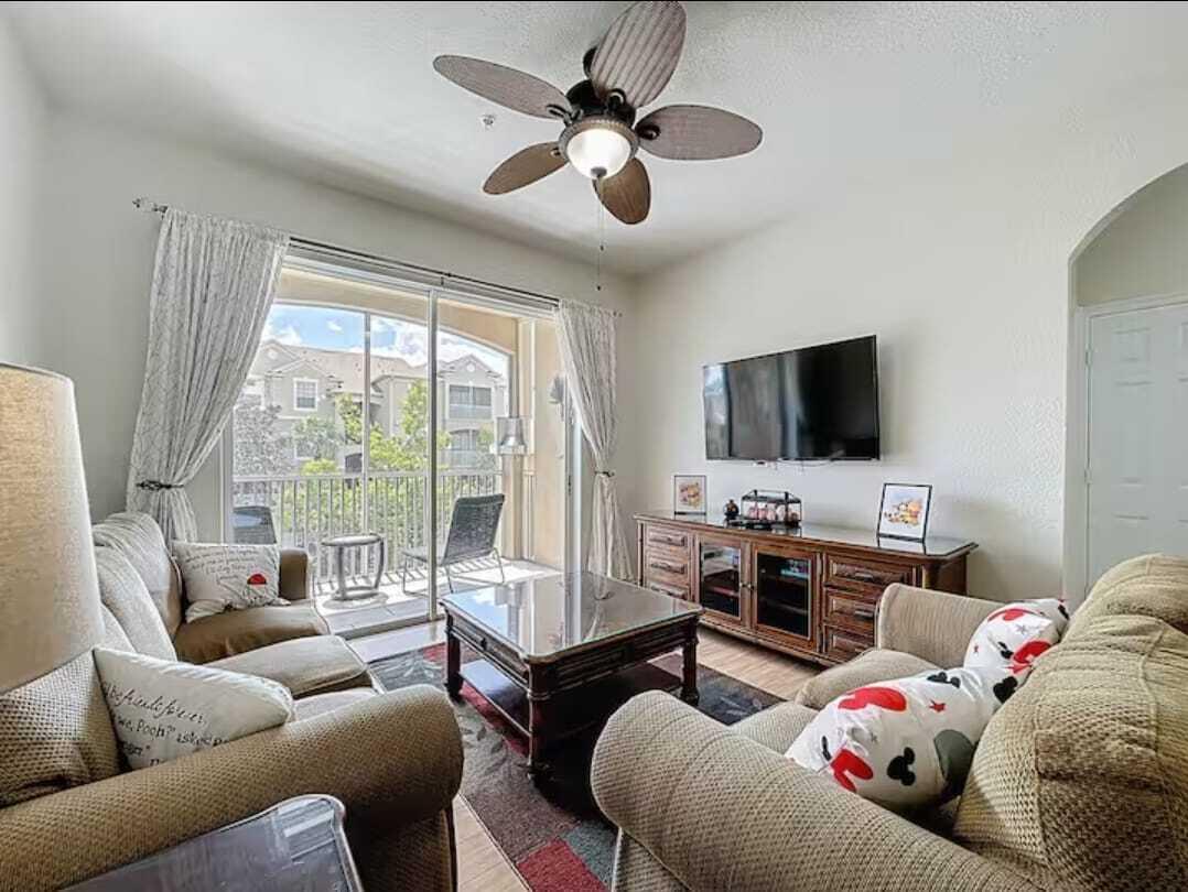 2784 Almaton Loop, Unit 301 Kissimmee, FL 34747 - Photo 2 of 37 a living room with furniture and a flat screen tv