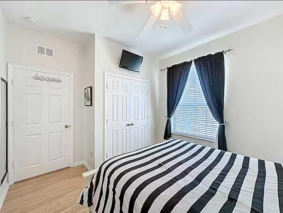 2784 Almaton Loop, Unit 301 Kissimmee, FL 34747 - Photo 23 of 37 a bedroom with a bed and a flat tv screen