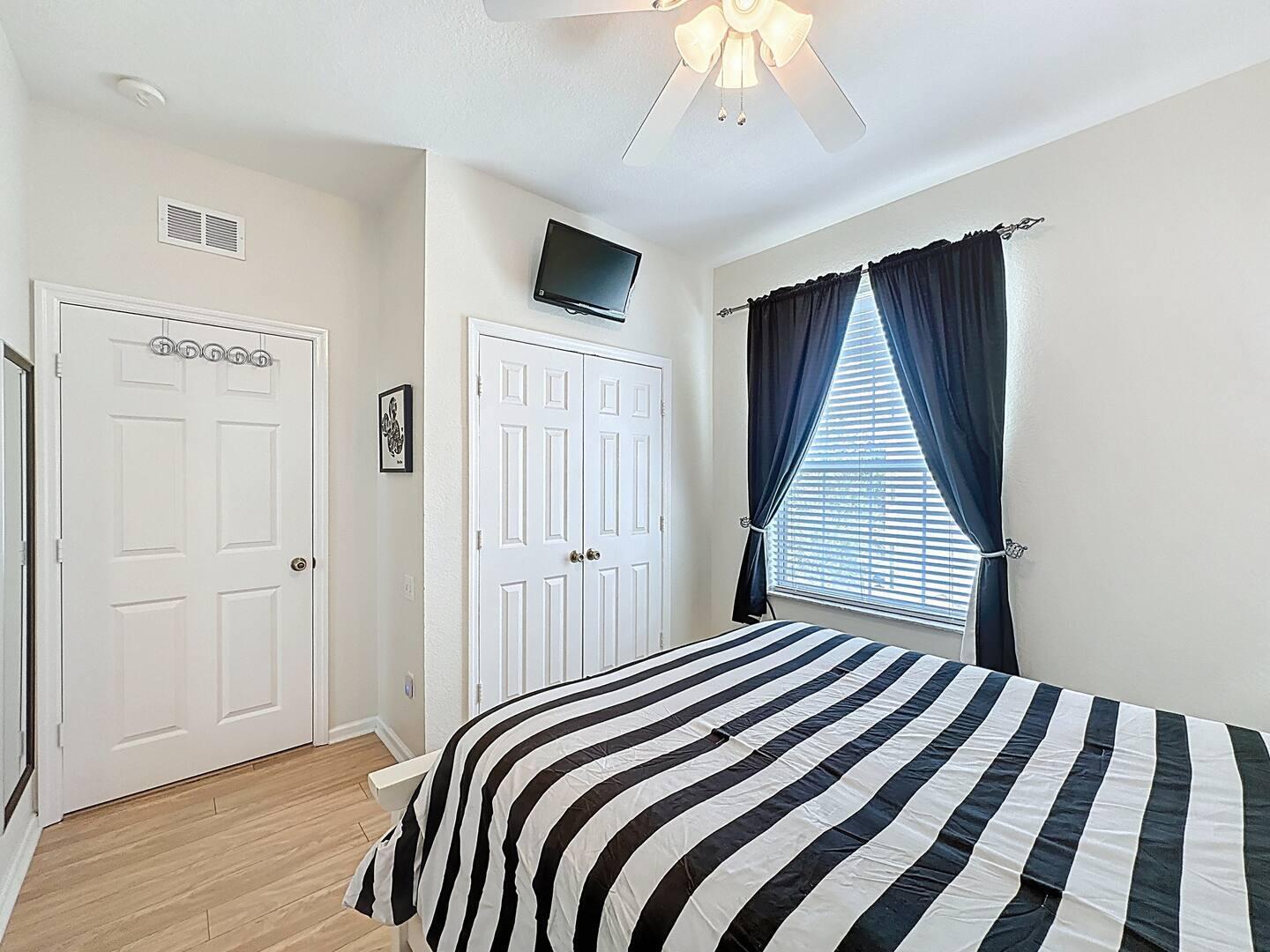 2784 Almaton Loop, Unit 301 Kissimmee, FL 34747 - Photo 24 of 37 a bedroom with a bed and a flat tv screen