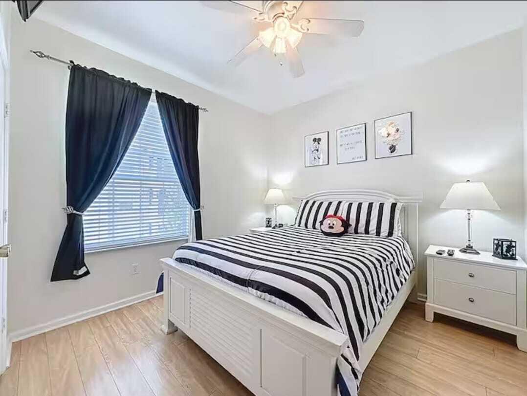 2784 Almaton Loop, Unit 301 Kissimmee, FL 34747 - Photo 25 of 37 a bedroom with double bed and a window