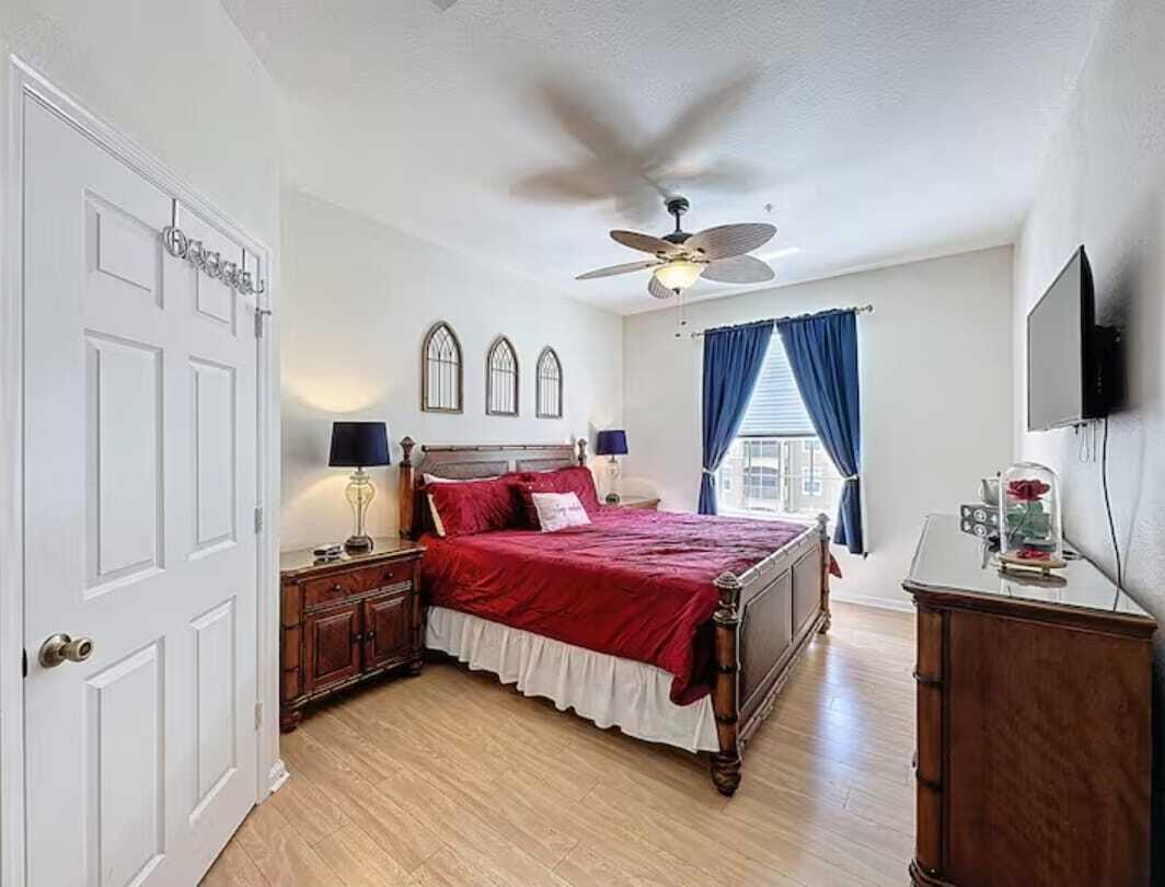 2784 Almaton Loop, Unit 301 Kissimmee, FL 34747 - Photo 29 of 37 a bedroom with a bed and a flat tv screen on the dresser