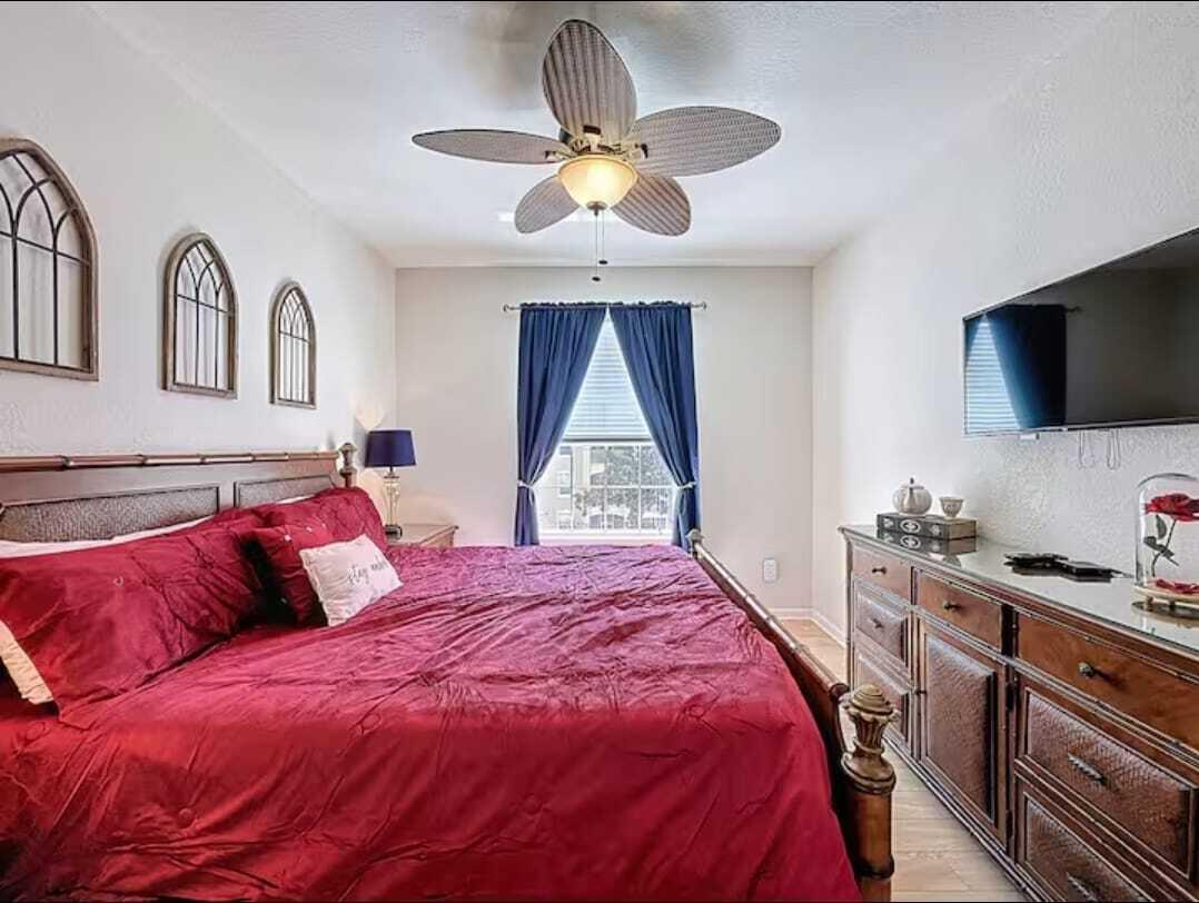 2784 Almaton Loop, Unit 301 Kissimmee, FL 34747 - Photo 30 of 37 a bedroom with a bed and a flat screen tv