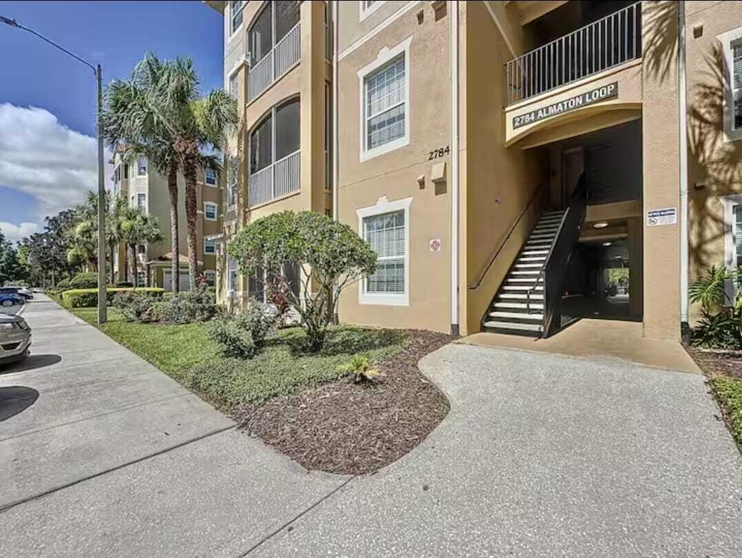 2784 Almaton Loop, Unit 301 Kissimmee, FL 34747 - Photo 32 of 37 a front view of a house with a yard