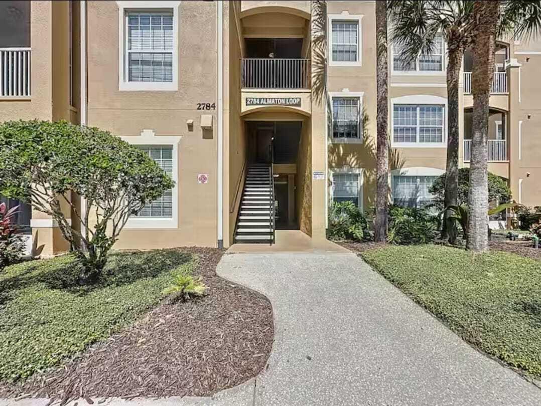 2784 Almaton Loop, Unit 301 Kissimmee, FL 34747 - Photo 33 of 37 front view of a house with a yard