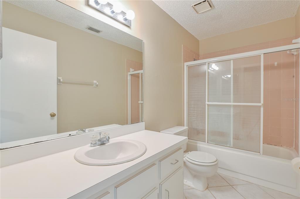 11001 Southeast Sunset Harbor Road, Unit H52 Summerfield, FL 34491 - Photo 10 of 31 a bathroom with a sink a toilet and shower