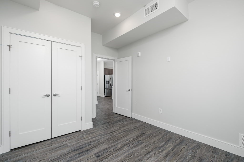 16 Laurel Street, Unit 201 Everett, MA 02149 - Photo 20 of 27 a view of an empty room with wooden floor