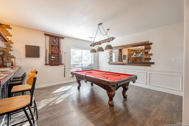 a room with furniture and pool table