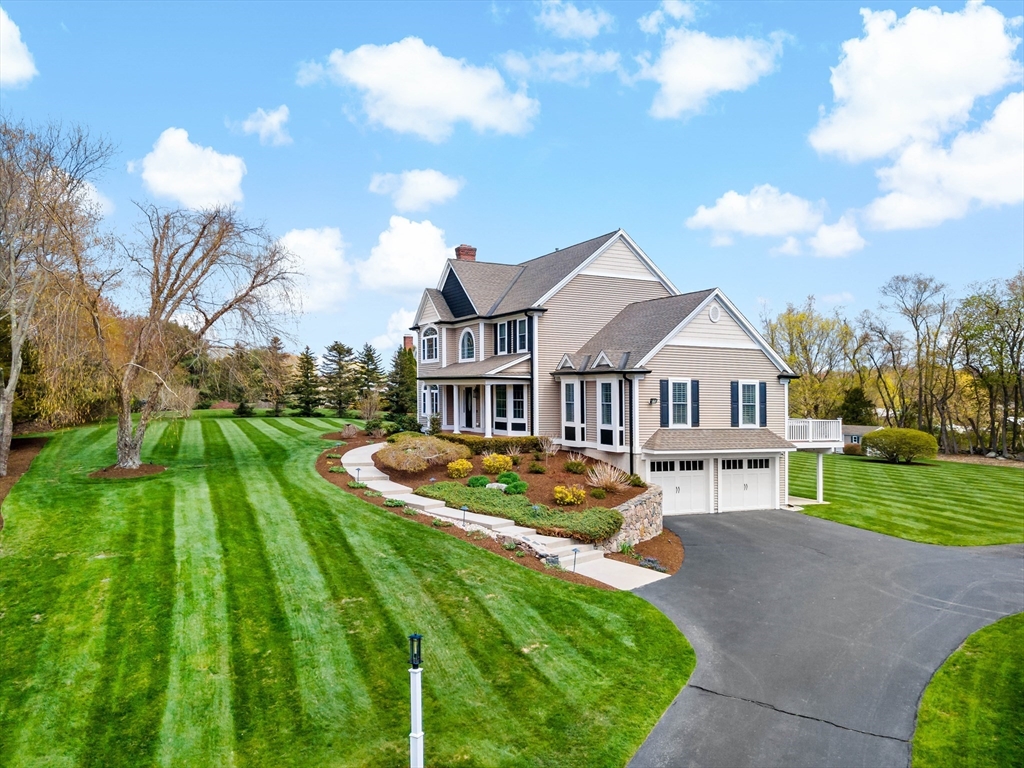 9 Round Farm Road Rehoboth, MA 02769 - Photo 2 of 41 a front view of a house with garden and trees