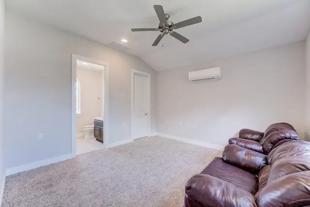 a living room with furniture and a ceiling fan