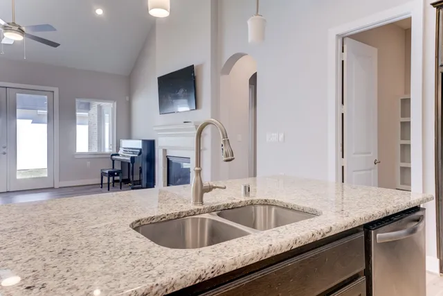 a kitchen with a sink and a wooden floor