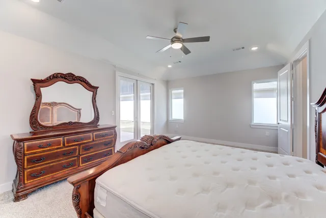 a bedroom with a bed and a dresser