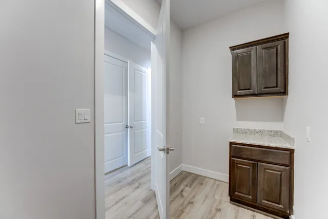 a view of a kitchen with a sink dryer and cabinets