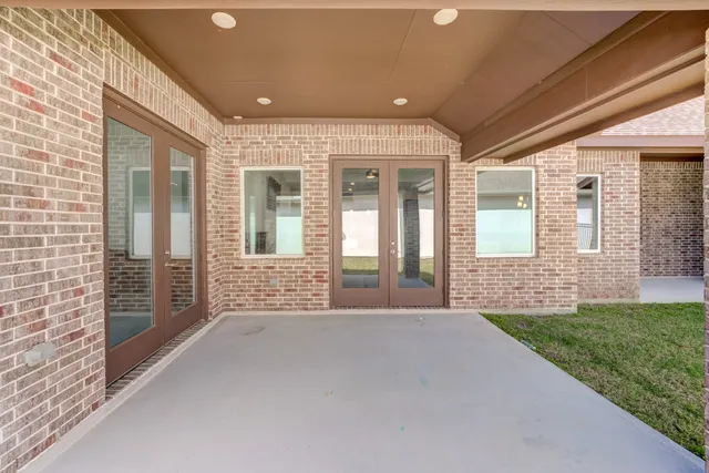a bathroom with a shower and a glass door