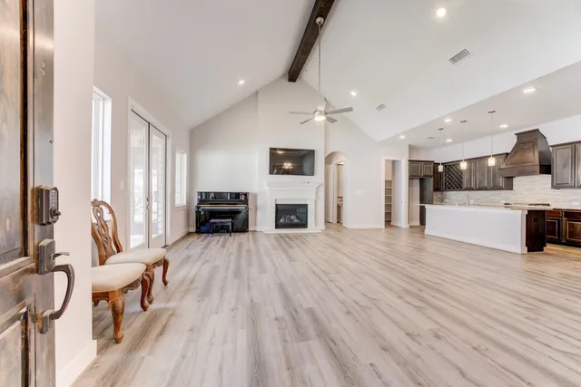 a view of a kitchen with furniture and wooden floor