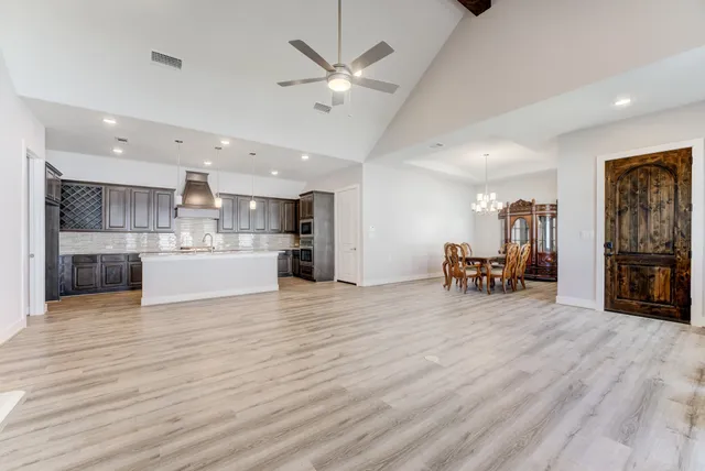a view of a livingroom with a kitchen and furniture