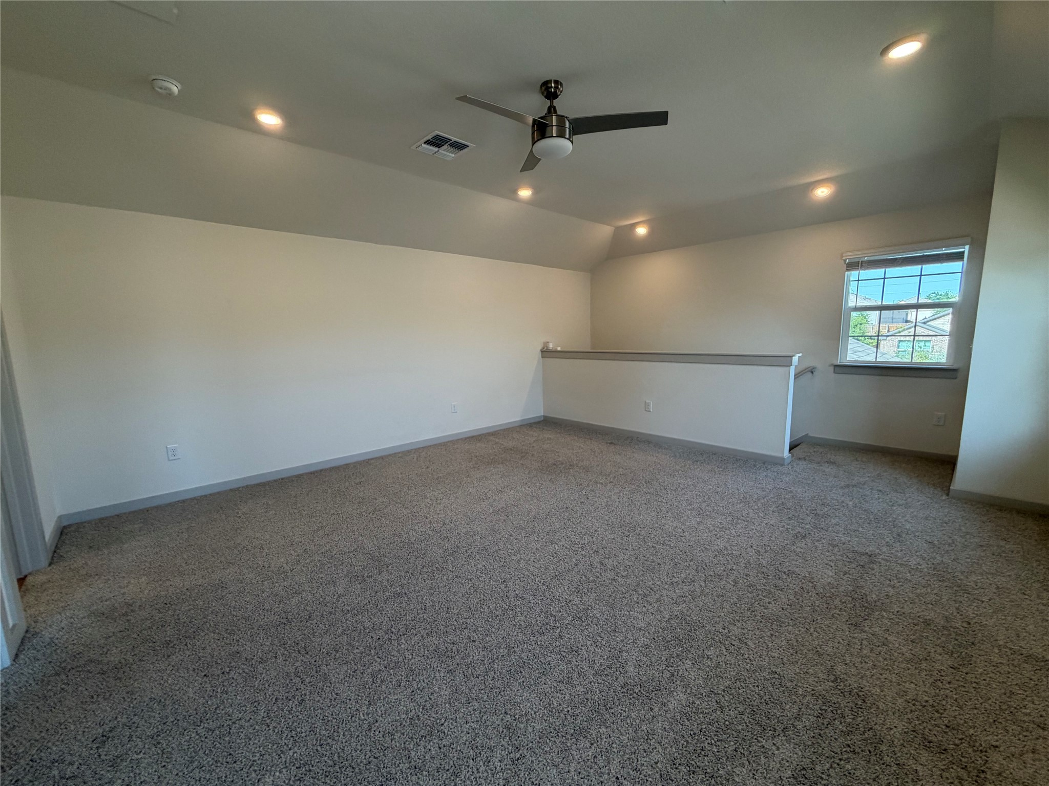 10708 Gonzales Ranger Pass Austin, TX 78754 - Photo 30 of 40 A versatile open-concept space featuring recessed lighting, plush carpeting, and a modern ceiling fan.