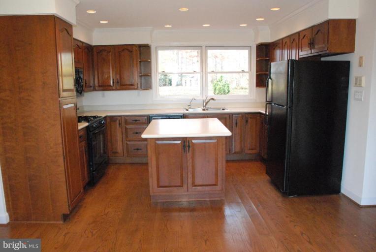 15500 Tierra Drive Silver Spring, MD 20906 - Photo 12 of 21 a kitchen with stainless steel appliances granite countertop a refrigerator a sink a stove and island