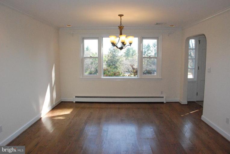 15500 Tierra Drive Silver Spring, MD 20906 - Photo 13 of 21 a view of an empty room with wooden floor and a window