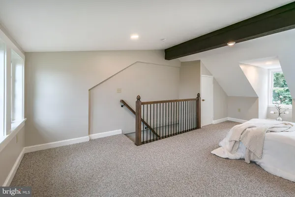 a bedroom with a large bed and a window