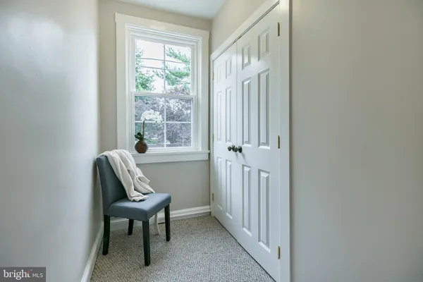 a view of a hallway with wooden floor and closet