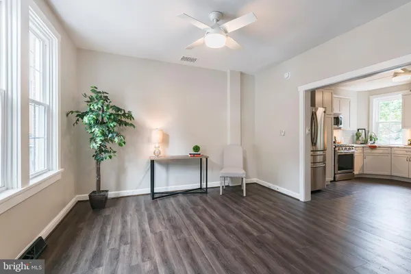 a view of a room with wooden floor and a potted plant