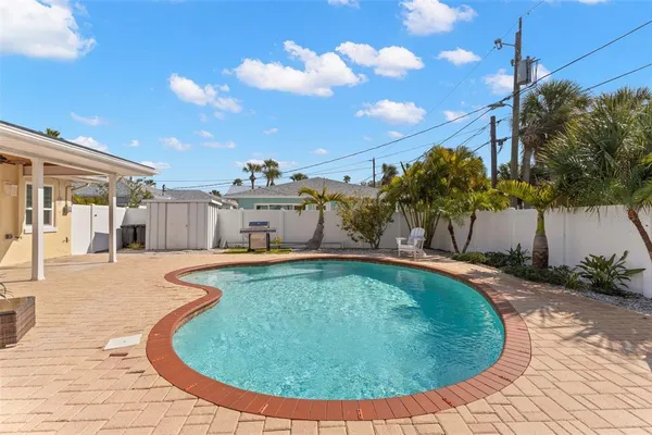 a swimming pool with outdoor seating and yard