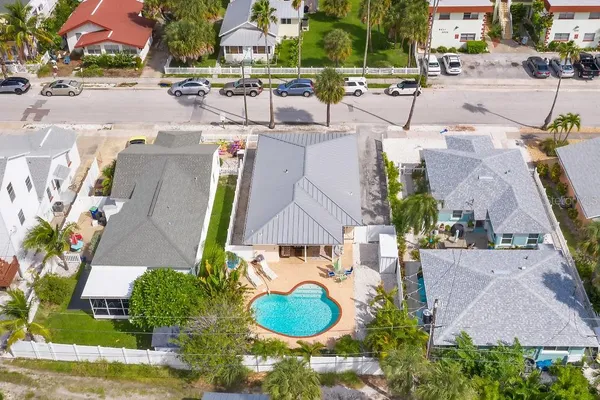 an aerial view of residential houses with outdoor space and parking