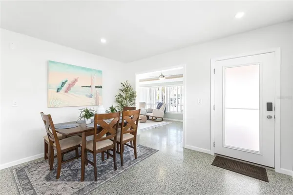a dining room with furniture and wooden floor