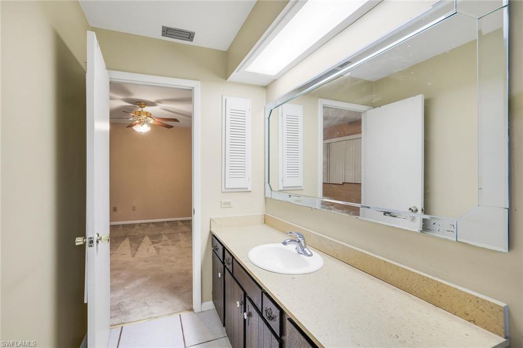 5290 Cypress Lane Naples, FL 34113 - Photo 20 of 39 a bathroom with a sink double vanity and a mirror