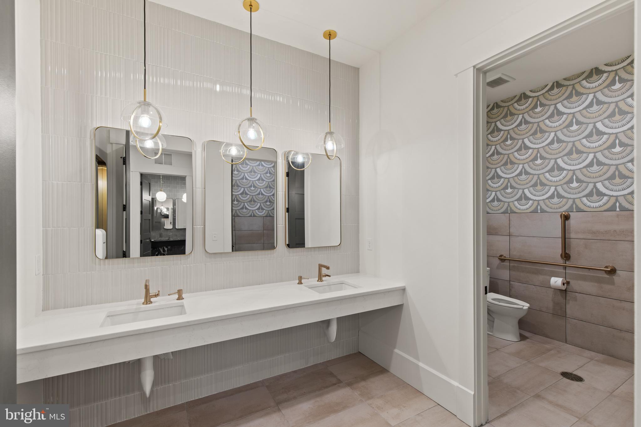 2320 Hadley Boulevard, Unit 101 Enola, PA 17025 - Photo 25 of 31 a bathroom with a sink a toilet a mirror and shower