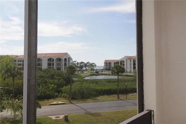 a living room with furniture a large window and a flat screen tv