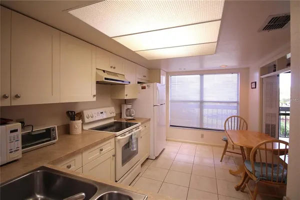 a kitchen with a stove a sink and a refrigerator