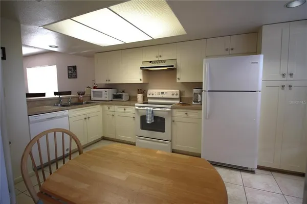 a bedroom with a bed and a tv on table