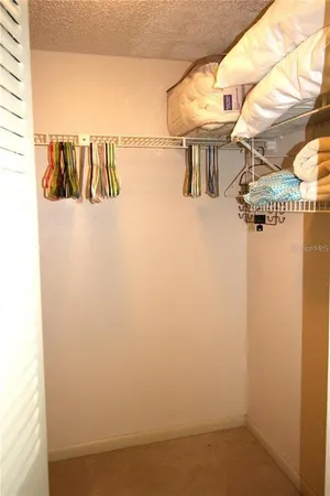 a bedroom with a bed and a television