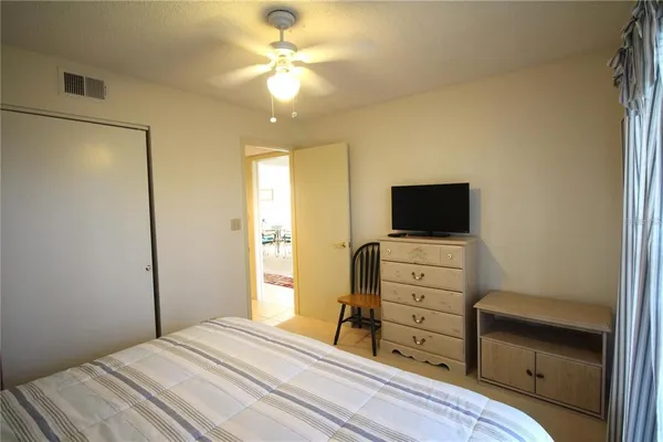 a view of a patio with a dining table and chairs with plants