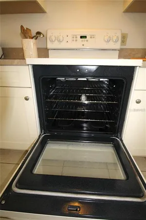 a view of a patio with a table chairs and a umbrella