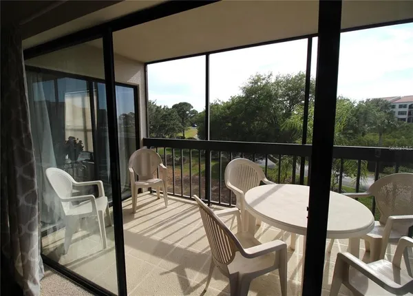 a view of a dining room with furniture and a chandelier