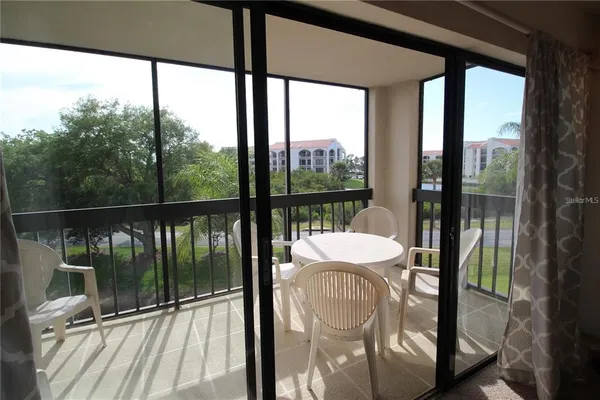 a view of a dining room with furniture and a window