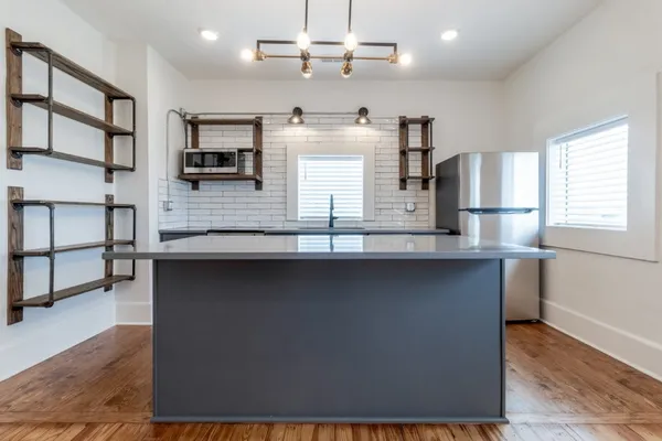 a kitchen with counter top space cabinets and stainless steel appliances