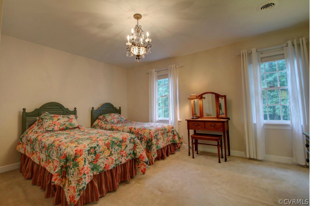 14101 Grangewood Road Midlothian, VA 23113 - Photo 13 of 17 a bedroom with two beds and a chandelier