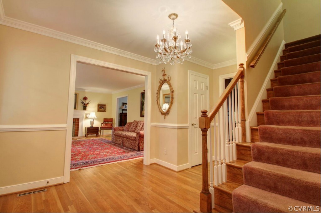 14101 Grangewood Road Midlothian, VA 23113 - Photo 2 of 17 a view of a livingroom with wooden floor and stairs