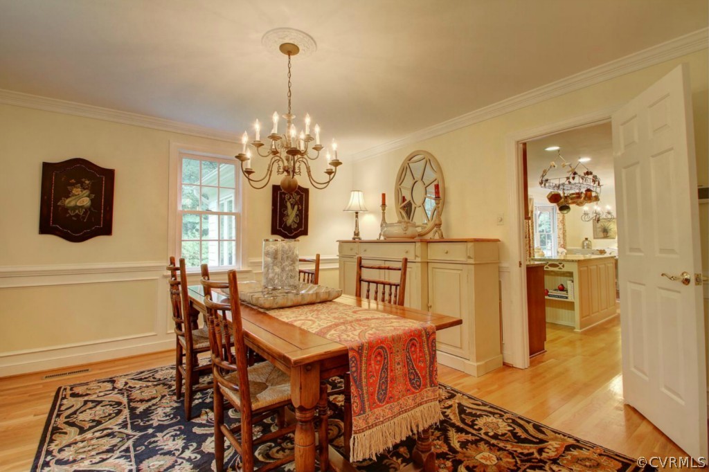 14101 Grangewood Road Midlothian, VA 23113 - Photo 4 of 17 a view of a dining room with furniture and chandelier