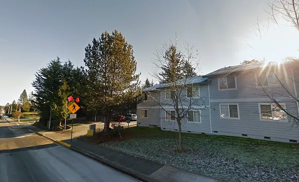 a view of a house with a yard