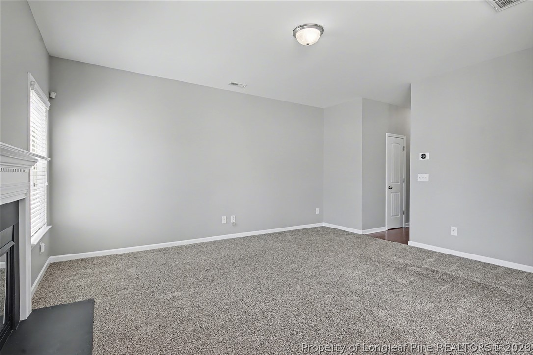 61 Bicentennial Way Cameron, NC 28326 - Photo 11 of 49 an empty room with a fireplace