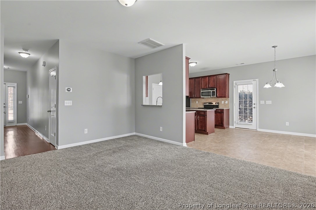 61 Bicentennial Way Cameron, NC 28326 - Photo 12 of 49 a view of a kitchen with a sink and a refrigerator