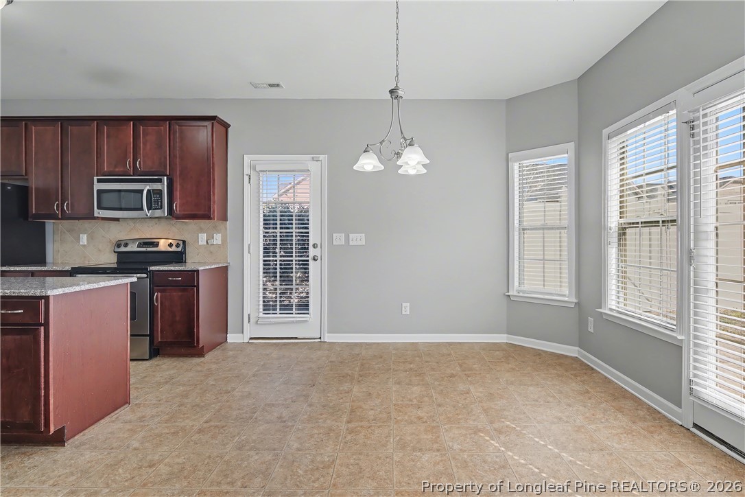 61 Bicentennial Way Cameron, NC 28326 - Photo 13 of 49 a kitchen with kitchen island a counter top space appliances and a window