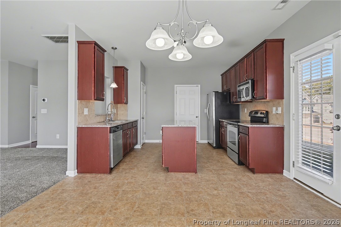 61 Bicentennial Way Cameron, NC 28326 - Photo 15 of 49 a kitchen with stainless steel appliances granite countertop a sink dishwasher stove and refrigerator